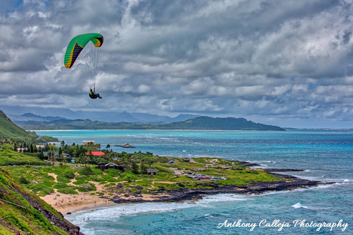 Photo of an individual hang gliding above Makapuu Beach photographed from Makapuu Lookout, Oahu, Hawaii