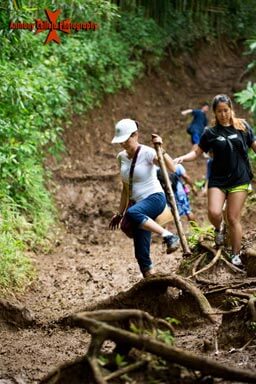 Hikers on the trail to the waterfalls of Manoa, A bamboo stick can be very useful and can be found on the trail to the waterfall