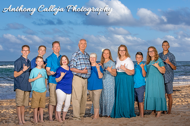 Family Portrait of a family of twelve giving the shaka sign at Papailoa Beach, North Shore, Oahu