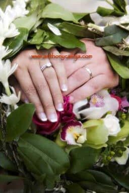 Oahu Wedding Portrait of the bride and grooms hand with rings flower bouquet and maili lei