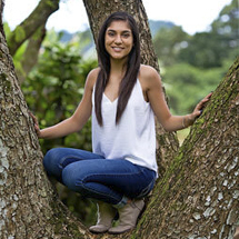 Honolulu Senior Portraits - Graduation portrait of a young lady in a tree at Hoomaluhia Botanical Gardens, Kaneohe, HI 