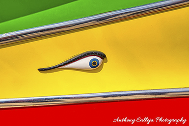 The eyes on Maltese Luzzu boats, particularly on the bow, are a significant symbol with deep historical and cultural roots. They are believed to be a modern survival of ancient Phoenician traditions, also practiced by ancient Greeks and Egyptians, and are referred to as the Eye of Horus or Eye of Osiris. These eyes are thought to protect fishermen from harm while at sea, ward off evil spirits, and ensure a safe return. 