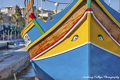 A luzzu is a traditional Maltese fishing boat, often brightly painted and featuring an eye on the bow as a symbol of protection, according to Wikipedia and other sources. The word "luzzu" is of Sicilian origin, referring to a type of fishing boat. They are commonly seen in fishing villages like Marsaxlokk and Marsascala. 