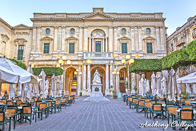 A statue of Queen Victoria stands in front of the National Library of Malta in Republic Square, Valletta, Malta. Sculpted out of marble by the Sicilian artist Giuseppe Valenti, the statue depicts the Queen sitting down and wearing a shawl of Maltese lace. It was installed in the square on 5 August 1891, replacing a bronze statue of António Manoel de Vilhena.