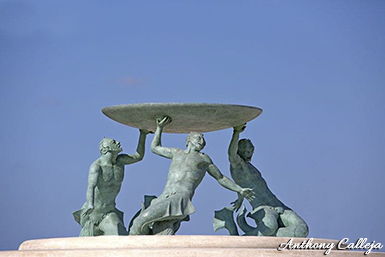 The Tritons’ Fountain is a fountain located in Floriana, Malta. It consists of three bronze Tritons holding up a large basin, balanced on a concentric base built out of concrete and clad in 730 tons of travertine slabs. The fountain is one of Malta's most important Modernist landmarks.
